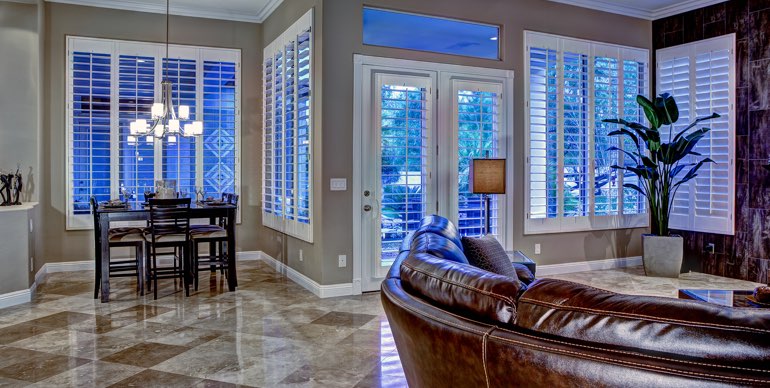 Jacksonville great room with plantation shutters and tile floor.
